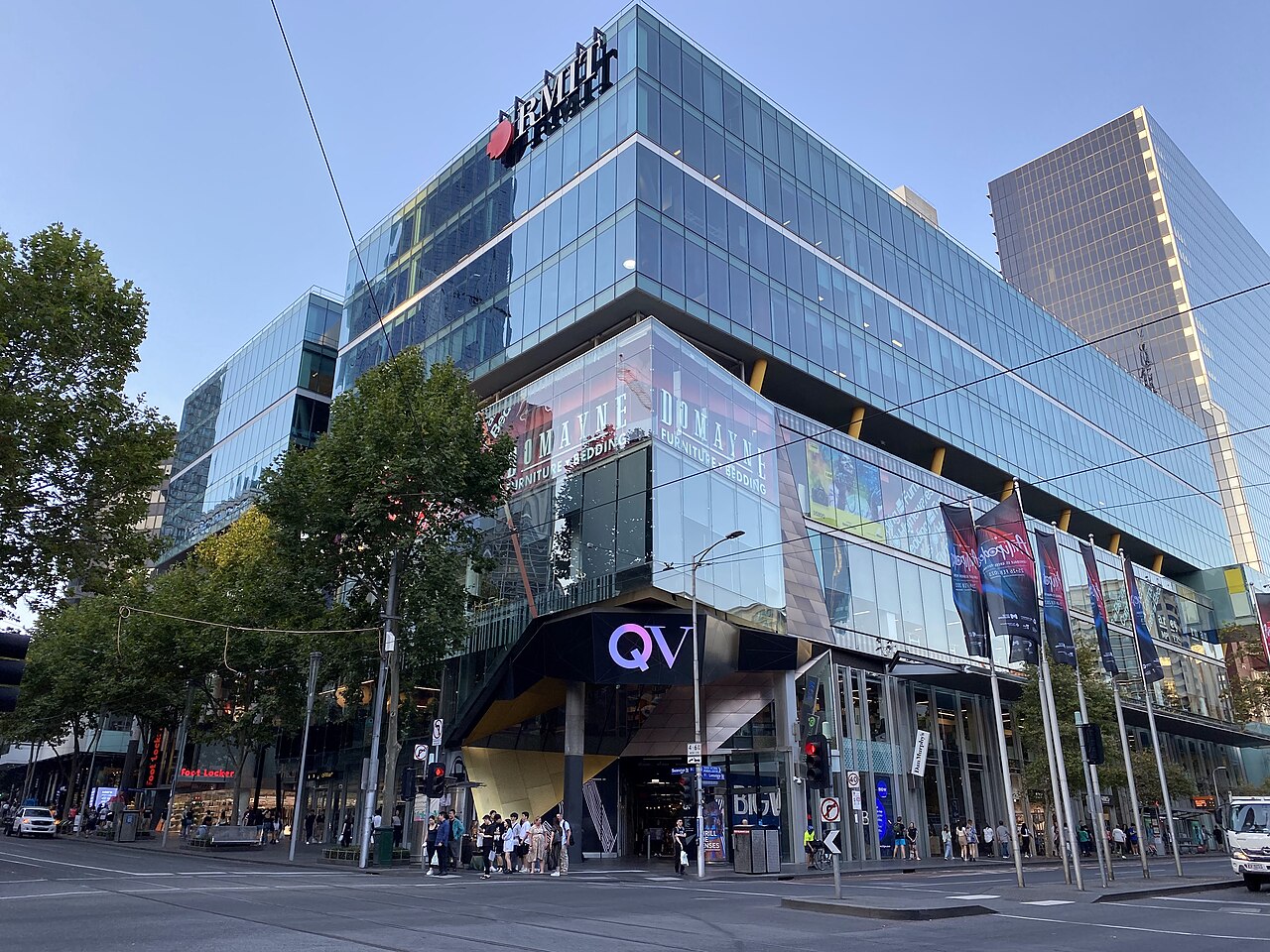 QV Melbourne shopping centre entrance and illuminated QV sign at the corner of Swanston and Lonsdale streets
